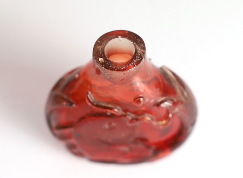 A Chinese ruby red glass ‘leaping carp’ snuff bottle, 1750-1850, 5.9cm high